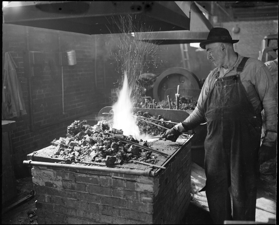 Blacksmith and his forge. The Pocahontas Corporation, Mines 33-34, Bishop, Tazewell County, Virginia. - NARA - 541077