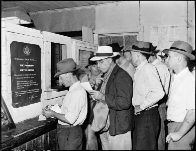 Blaine Sergent, third in line, at the pay window. P V & K Coal Company, Clover Gap Mine, Lejunior, Harlan County... - NARA - 541332