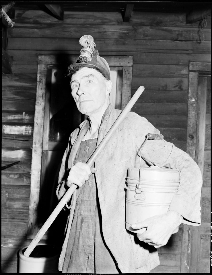 Blaine Sergent ready to go to the mines. Short pole in his right hand is used to provide extra support as he walks... - NARA - 541384
