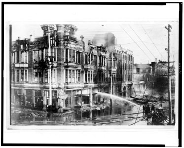 Block of burned buildings in San Francisco after the 1906 earthquake with fire truck spraying water on them LCCN95504347