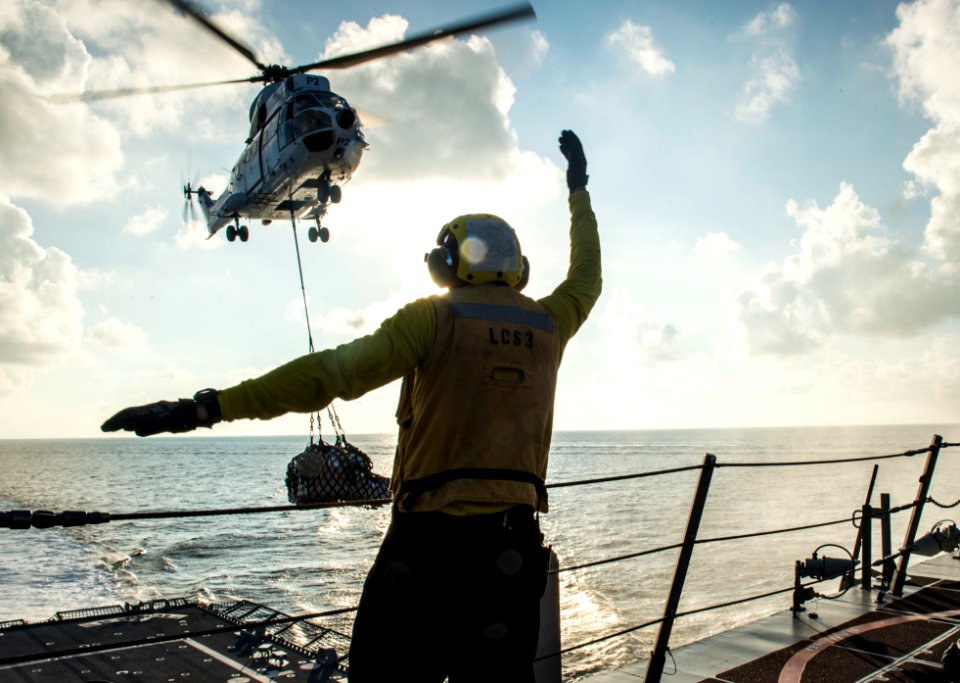 Boatswain's Mate 2nd Class Ricky Jones guides in an Aerospatiale SA 330 Puma helicopter for a vertical replenishment from USNS Amelia Earhart