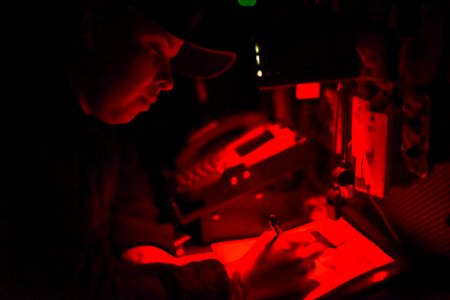 Boatswain’s Mate 2nd Class Cassandra Liriano, from Frederick, Md., writes in a deck log aboard the aircraft carrier USS Theodore Roosevelt (CVN-71) on May 11, 2019 photo
