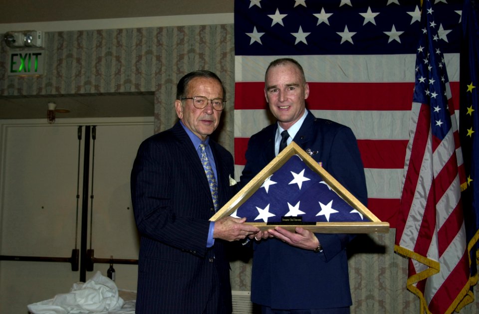 Bob Dulaney presents an American Flag to Ted Stevens