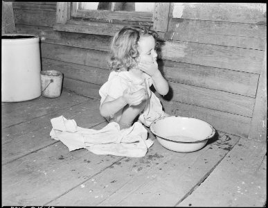 Bobbie Jean Sergent, 4, washes her face on the backporch of her home. P V & K Coal Company, Clover Gap Mine... - NARA - 541306