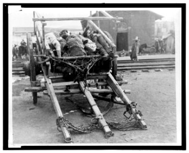 Bodies of dead men piled on a cart LCCN2006679491