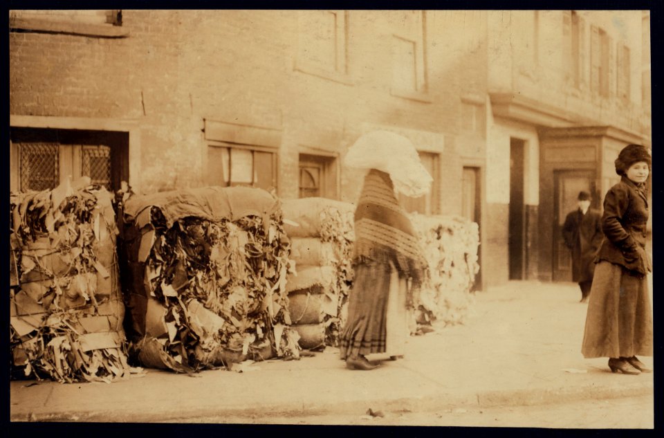 Carrying underwear back to the factory through squalid surroundings. East Side near Brooklyn Bridge, N.Y. LOC nclc.04191