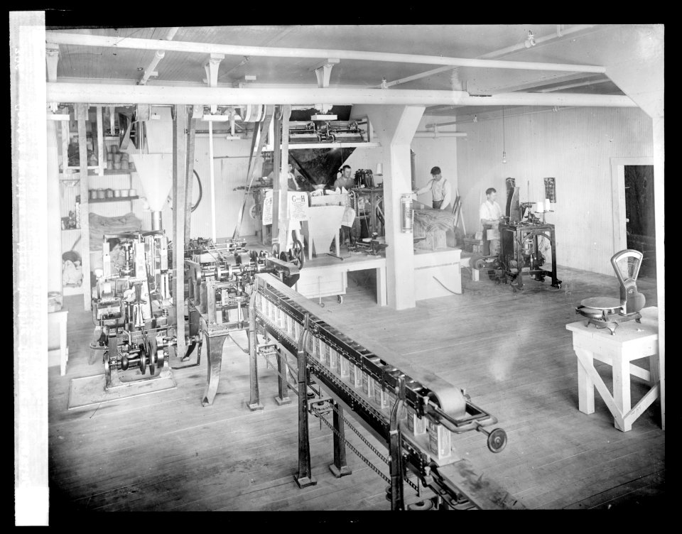 Carton Machine. Also showing filling and sewing 25 lb. sacks in background of picture LCCN2016824515