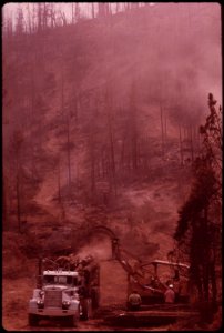 Caterpillar-tractor-loads-salvaged-logs-onto-pickering-truck-september-1973 7153127775 o