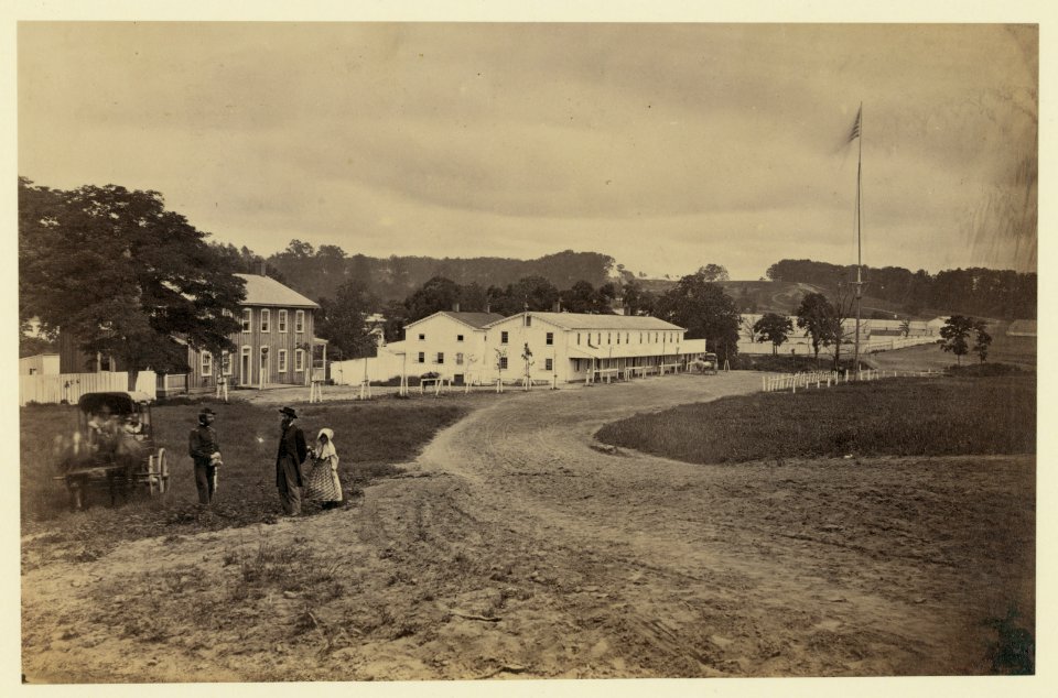 Cavalry depot at Giesboro, Md. Soldier facing man and girl with people in horse-drawn carriage in foreground LCCN91787364