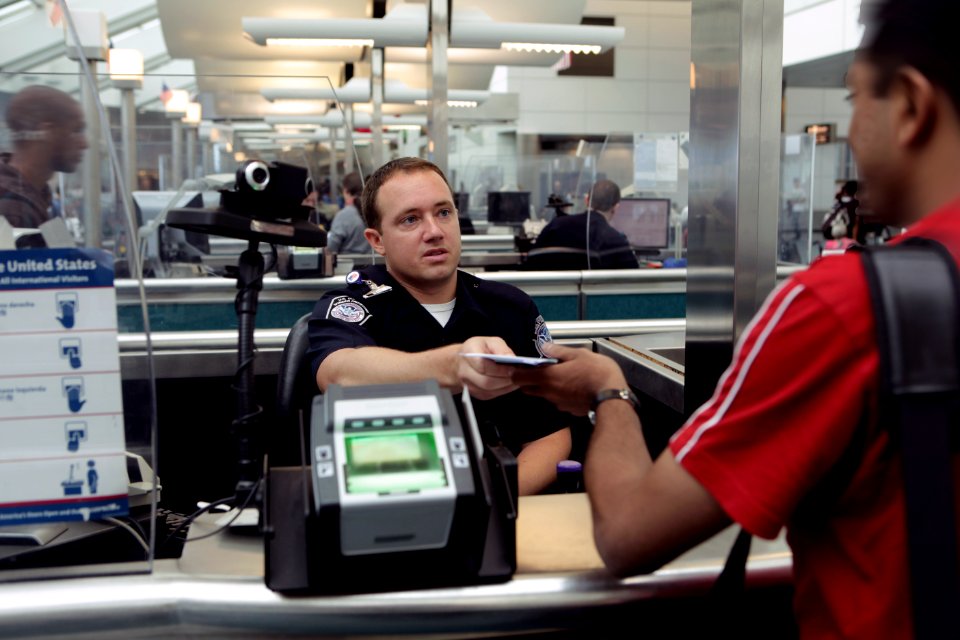CBP Officer processes incoming passenger