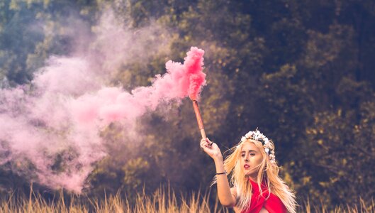 Woman in nature sweet colored smoke