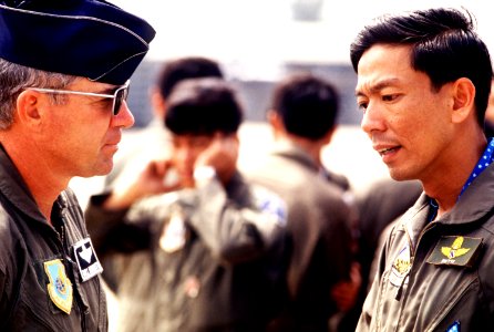 Colonel William Burnette, deployment commander, converses with Wing Commander Putti, Royal Thai Air Force, at the opening ceremony for joint US-Royal Thai Air Force Exercise COMMANDO WEST 89-1