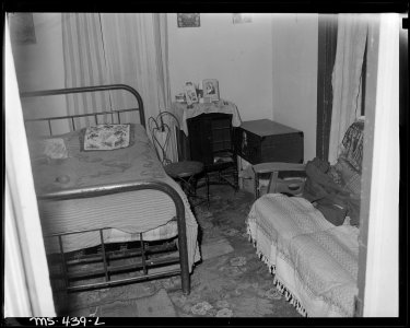 Combination living and bedroom of miner living in company housing project. Hi Heat Coal Company, Rains ^2 Mine... - NARA - 540412
