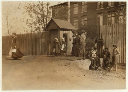 Coming out at noon, Merrimac Mills. All workers, even the boys at the side of the gate. LOC nclc.01905