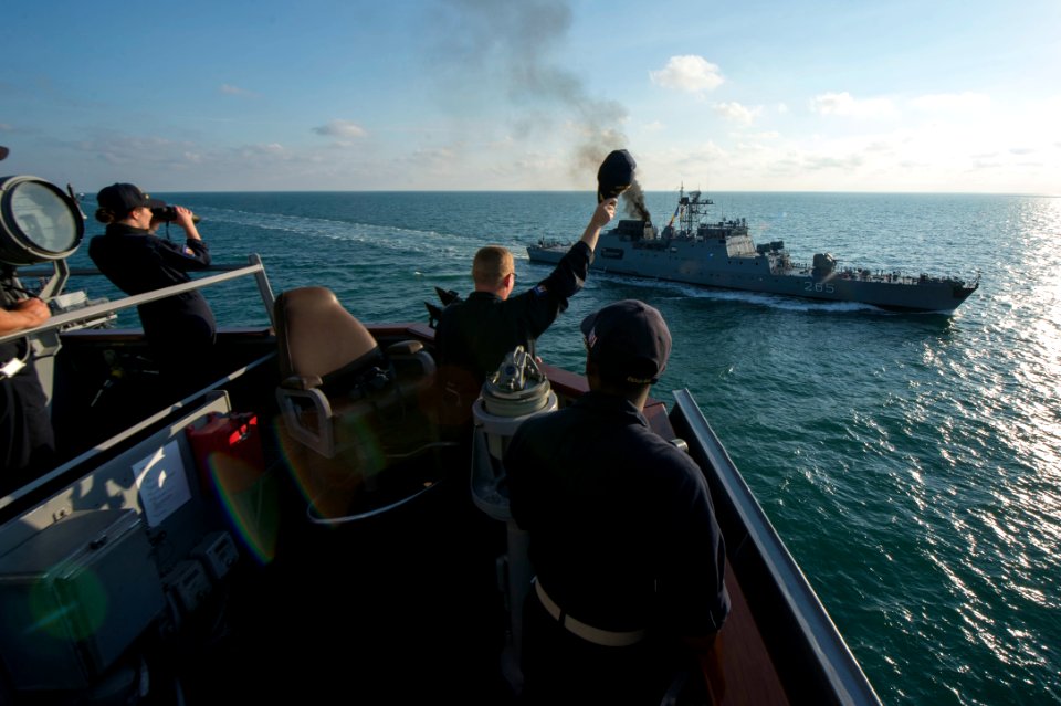 Commanding officer of USS Carney (DDG-64) waving to NMS Contraamiral Horia Macellariu (F-265) during replenishment-at-sea approach Sea Breeze 2017 170713-N-ZE250-157