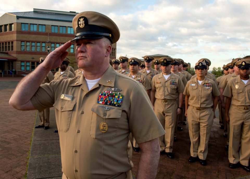 Command Master Chief Josh Dugan renders a salute for a formation of chief petty officers. (16835051888)