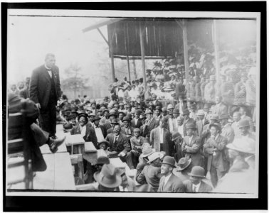 Booker T. Washington standing on a stage before large crowd in Lakeland LCCN98500613 photo