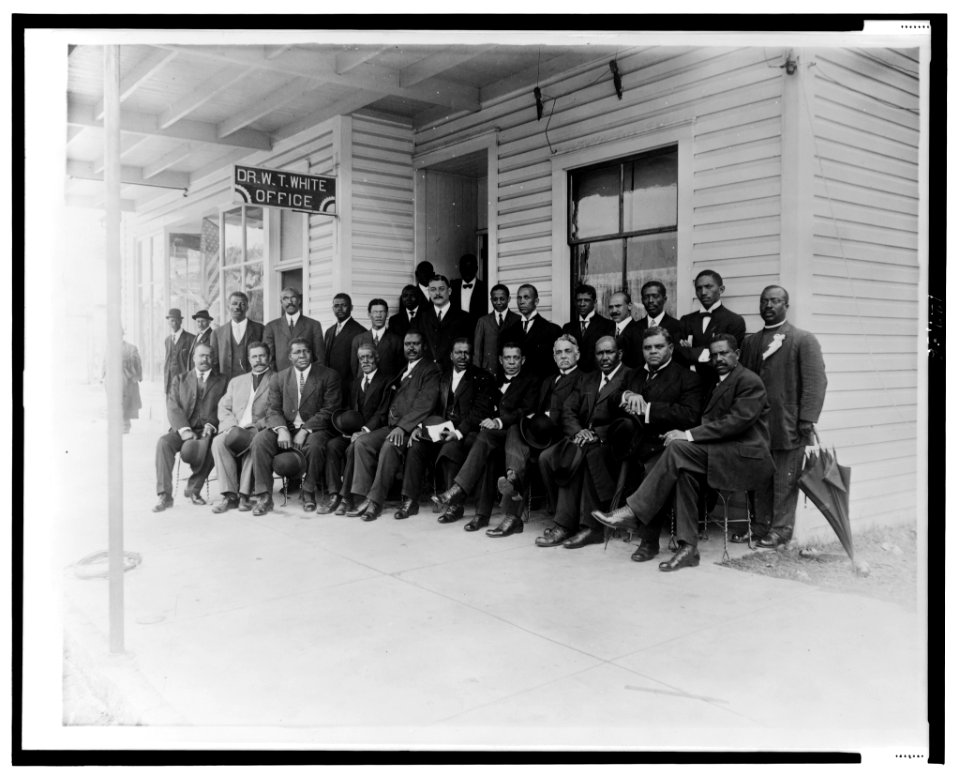 Booker T. Washington seated with group of men outside the office of Dr. W.T. White, in Palatka, Florida LCCN00652446