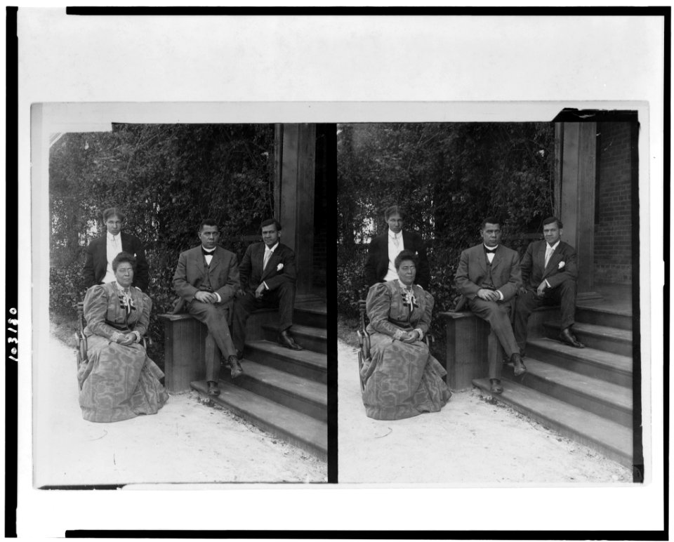 Booker T. Washington, seated on steps of porch, with wife and two sons LCCN91784317