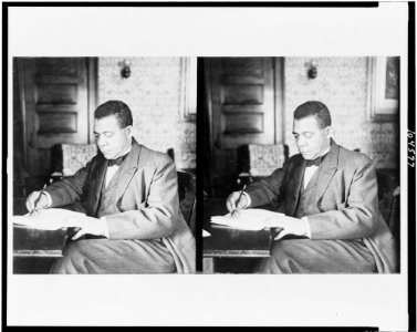 Booker T. Washington, three-quarter length portrait, seated, facing left, writing LCCN91794236 photo