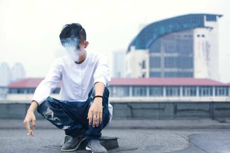 Sitting smoking cigarette photo
