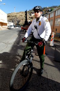 Border Patrol Agent Patrols Nogales Port on Bike photo