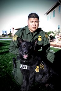 Border Patrol Agent Poses with Canine Partner