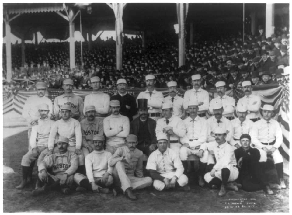 Boston and New York players on opening day, 1886, at the Polo Grounds, 5th Ave. & 110th St., N.Y.C. posed in front of stands; Boston player in back rowon left has his middle finger raised in LCCN2002715719