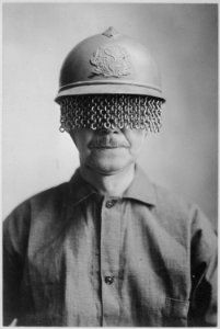 Chain screens on steel helmet to protect soldiers' eyes from fragments of shell, rock, etc., manufactured by E. J.... - NARA - 533656