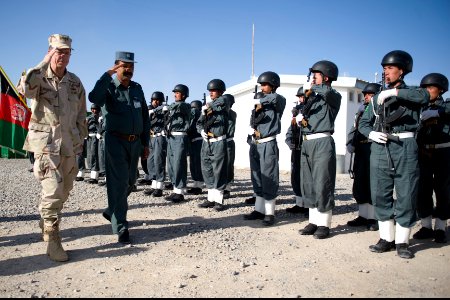 Chairman of the Joint Chiefs of Staff Navy Adm. Mike Mullen, left, reviews Afghan National Police during a welcoming ceremony at Forward Operating Base Walton, Kandahar, Afghanistan, April 24, 2009 090424-N-TT977-378