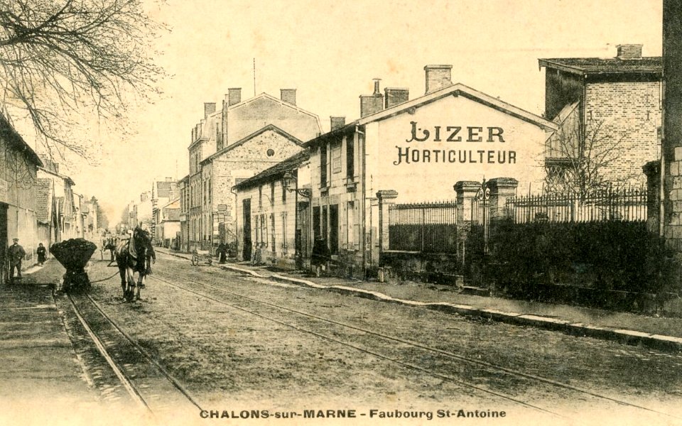Chalons-sur-Marne looking north along the Faubourg St. Antoine towards Reims. Metre-gauge track of the Chemins de Fer de la Banlieue de Reims (CBR) in the centre of the road and narrower-gauge track to the left