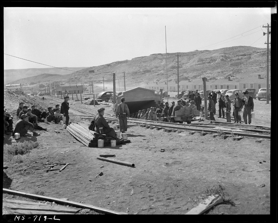 Changing shifts. Morning shift is being brought up on cars from underground. Miners of the afternoon shift are... - NARA - 540567