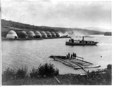 Charcoal kilns, the narrows, Chateaugay Lake, (Adirondack Mts., N.Y., small steamer and floating dock in foreground) LCCN2004667824 photo