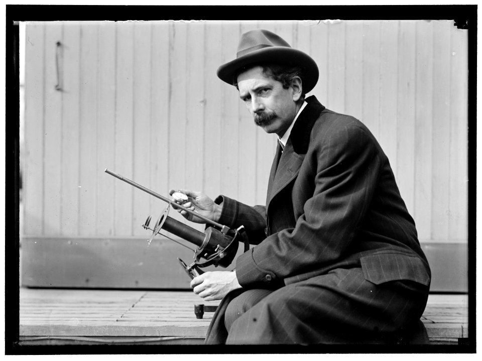 Charles Greeley Abbot, astrophysicist and Secretary of the Smithsonian, with his device- a silver-disc pyrheliometer which measures direct beam solar irradiance LOC hec.04703