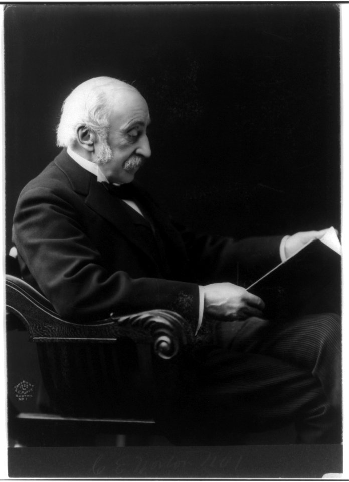 Charles Eliot Norton, 1827-1908, three-quarters length, seated, facing right; looking at book LCCN2005688920