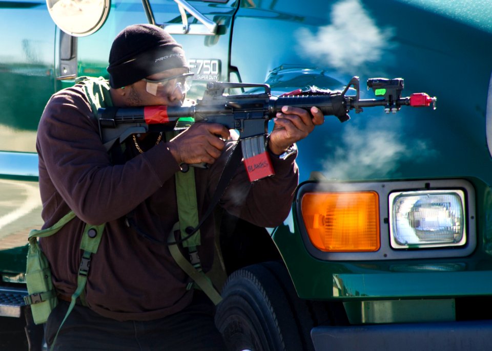 Charles Streat portrays the role of an active shooter Feb. 27, 2014, during a vehicle-borne improvised explosive device response exercise as part of Solid Curtain-Citadel Shield (SC-CS) 2014 at Naval Station 140227-N-XQ474-041
