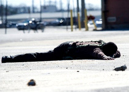 Charles Streat lays on the ground after being disarmed by U.S. Navy police Feb. 27, 2014, during a vehicle-borne improvised explosive device response exercise as part of Solid Curtain-Citadel Shield (SC-CS) 2014 140227-N-XQ474-051