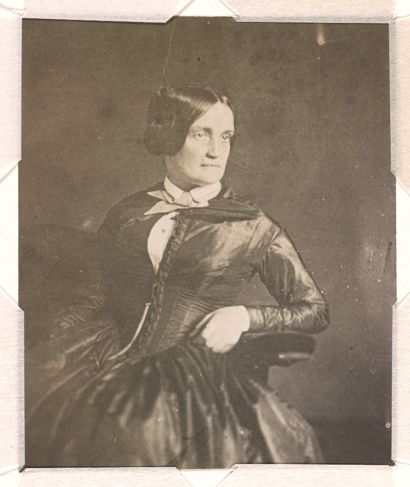 Charlotte Cushman, three-quarter length studio portrait, facing right, seated with her left arm resting on the arm of the chair LCCN2015651567