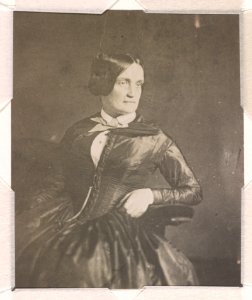 Charlotte Cushman, three-quarter length studio portrait, facing right, seated with her left arm resting on the arm of the chair LCCN2015651567