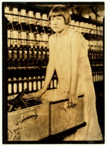 Cheney Silk Mills. Favorable working conditions. (Young girl worker at Cheney Silk Mills, leaning on scrap metal wagon, S. Manchester, Conn.) (No. 5002). LOC cph.3b04609