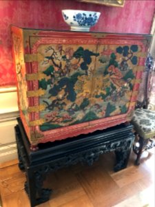 Chest with inlaid figures on Teakwood base