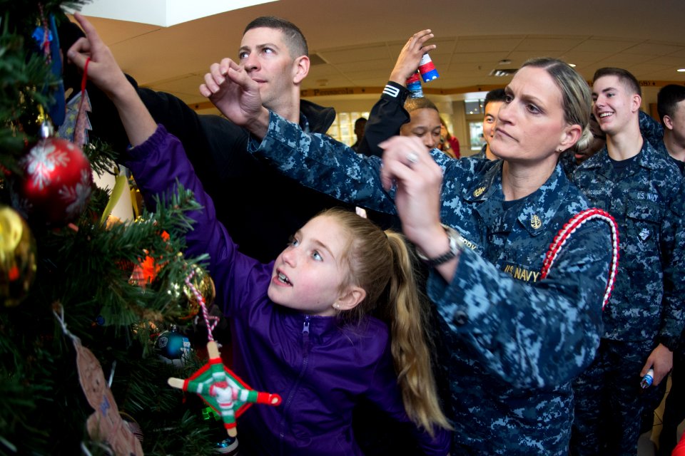 Chief Hospital Corpsman helps hang an ornament on a Christmas tree. (38005952245)