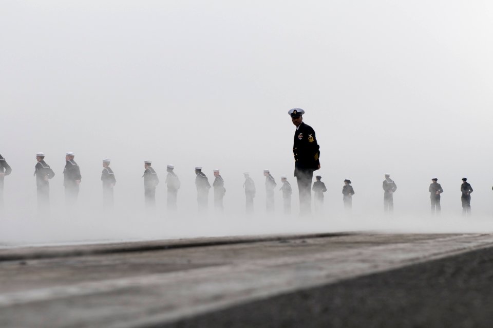 Chief Hospital Corpsman Webster Nicholson supervises Sailors manning the rails