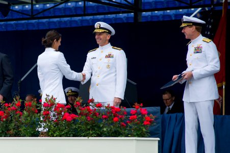 Chief of Naval Operations U.S. Navy Adm. Jonathan W. Greenert, center, congratulates U.S. Naval Academy midshipmen with the graduating class of 2013 as they cross the stage and receive their diplomas May 24 130524-N-WL435-884