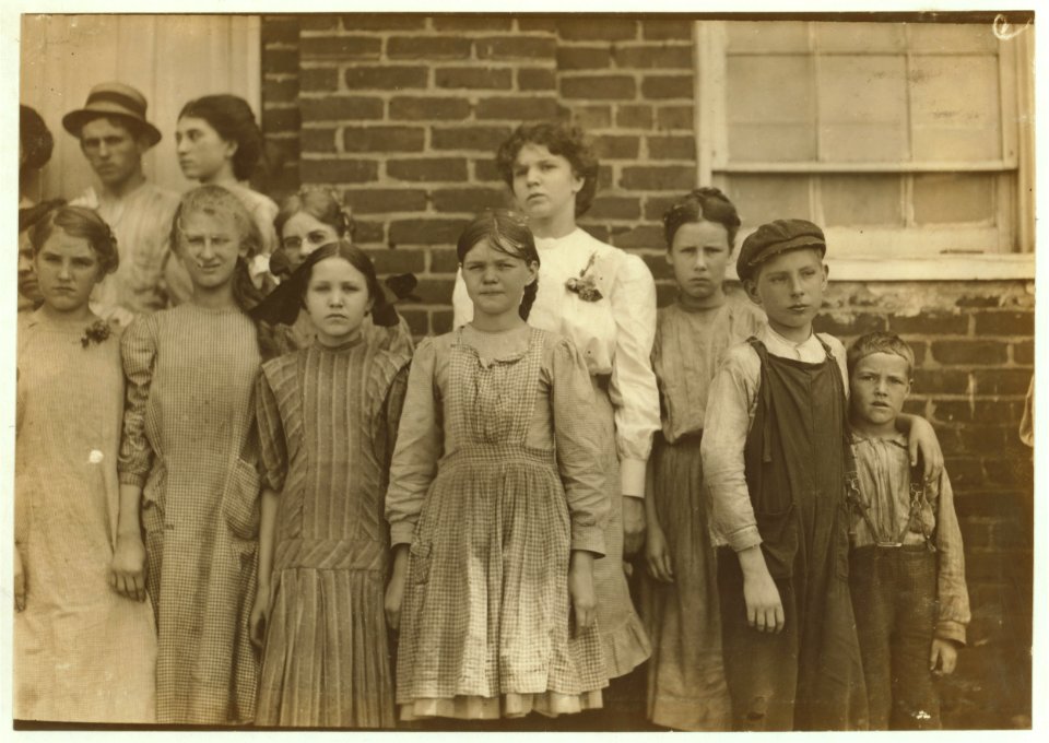 Comparison of Ages. Some of the youngest workers in Roanoke (Va.) Cotton Mills. On right-hand end is seven year old Frank, a helper. Next to him is twelve year old Ronald, a doffer. On his LOC nclc.02154