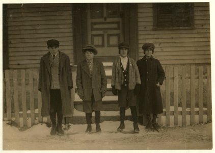 Comparison of Ages- Four Portuguese boys in front of home of Antone Mello, 26 County St. Boy on the left end (tallest) is a school boy. Said 13 years old. Boy on right end (shortest) is a LOC nclc.02478