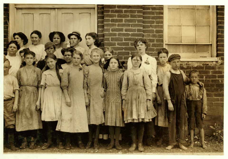 Comparison of Ages. Some of the youngest workers in Roanoke (Va.) Cotton Mills. On right-hand end is seven year old Frank, a helper. Next to him is twelve year old Ronald, a doffer. On his LOC nclc.02153