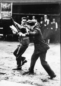 Confrontation between a policeman wielding a night stick and a striker during the San Francisco General Strike, 1934 - NARA - 541926