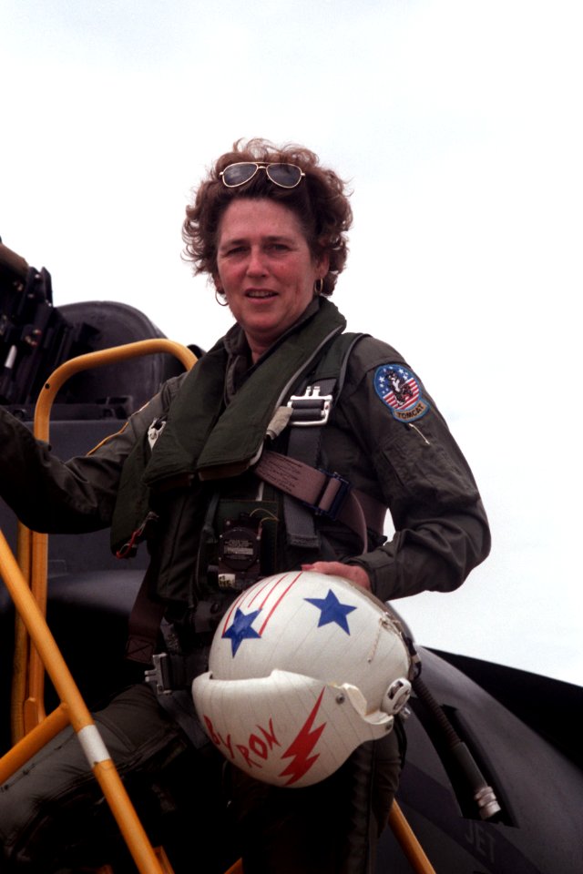 Congresswoman Beverly Byron pauses on the top step of an access ladder before climbing into the back seat of a Marine Corps TAV-8B Harrier aircraft for a demonstration flight