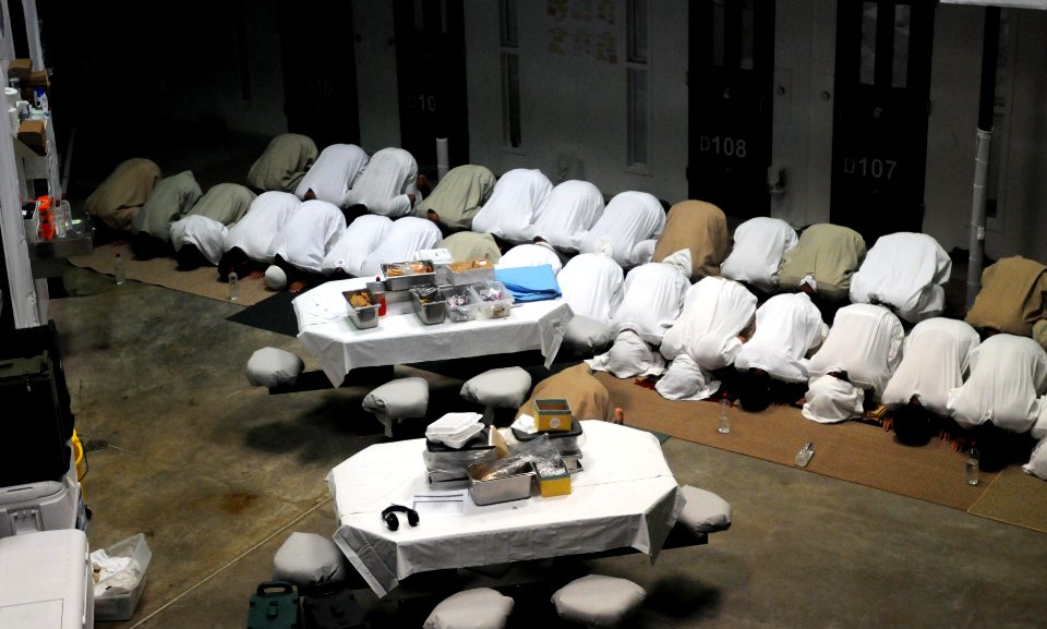 Detainees pray in a communal area of Camp Six at Joint Task Force Guantanamo DVIDS381036